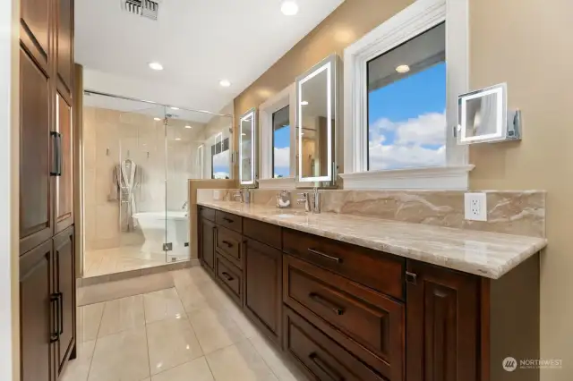 Primary bathroom with Italian marble floors and counter. Custom cabinets.