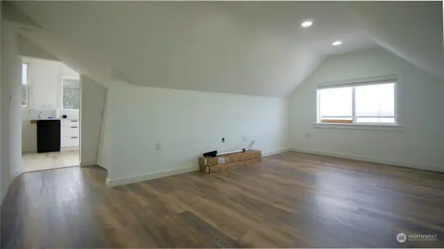 The second floor north bedroom is adjacent the kitchen. Closet area is behind photographer.