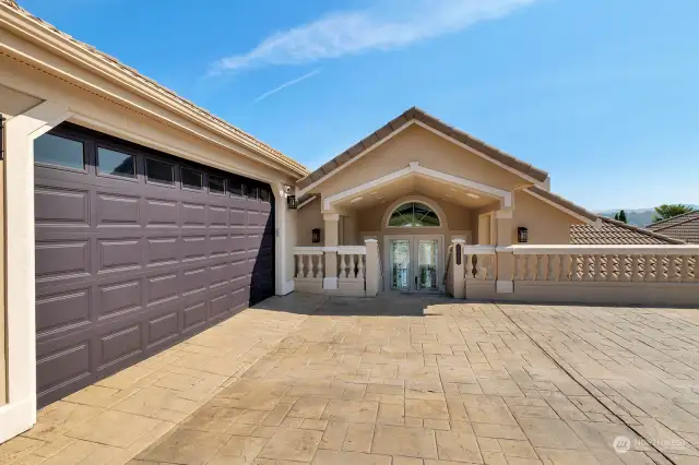 Fresh garage door and enough parking for five cars.