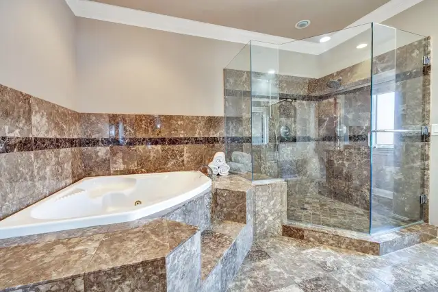 Custom marble bathroom with matching marble countertops and flooring