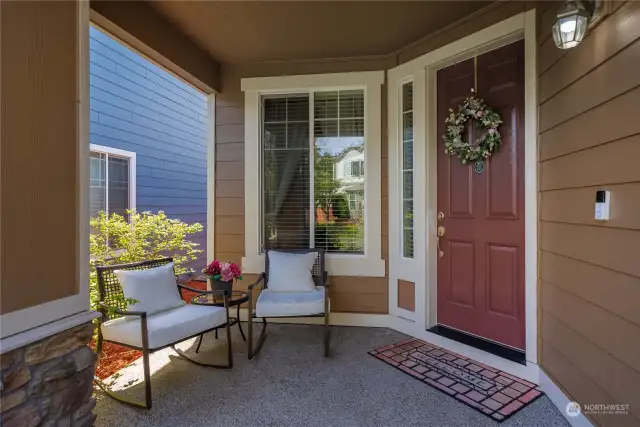 Step onto the covered front porch, greeted by an oversized door and the modern convenience of a Ring doorbell, ensuring security and comfort from the moment you arrive.
