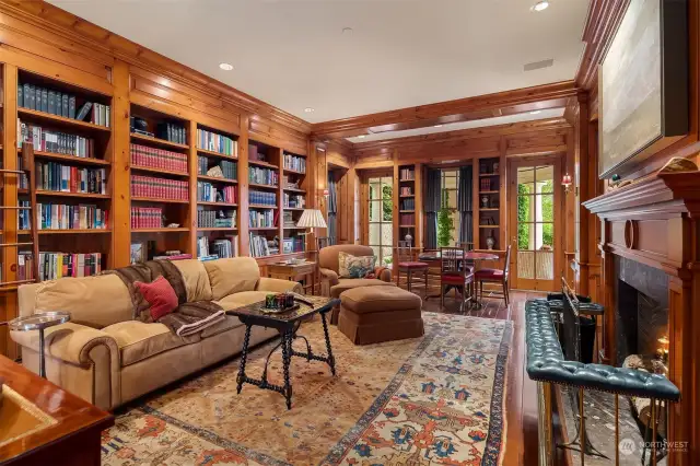 Leather and books and everything that comes with it! Rich pine paneled library floor to ceiling shelving and a stunning cosmos surround herringbone Rumford wood burning fireplace. Around the corner a private bar with undercounter fridge.