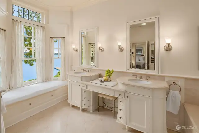 Listen to the waves lap from the dreamy primary bathroom adorned with luxurious limestone embellishments.