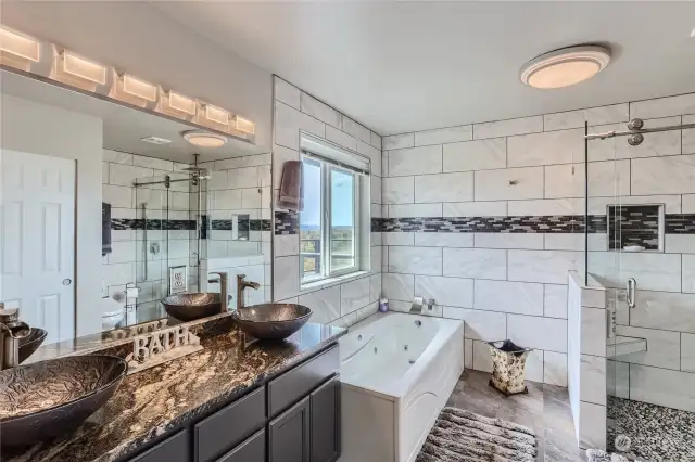 5 piece primary bathroom with soaking tub and walk in shower.