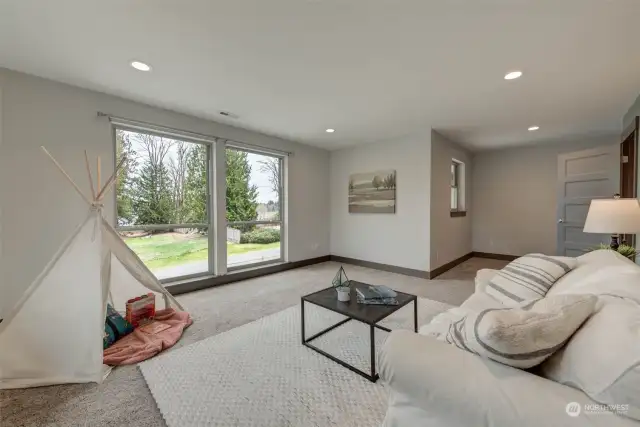 Upstairs livingroom w/ floor-to-ceiling windows that frame stunning views of Lake Cassidy, Mt. Pilchuck & morning sunrises!