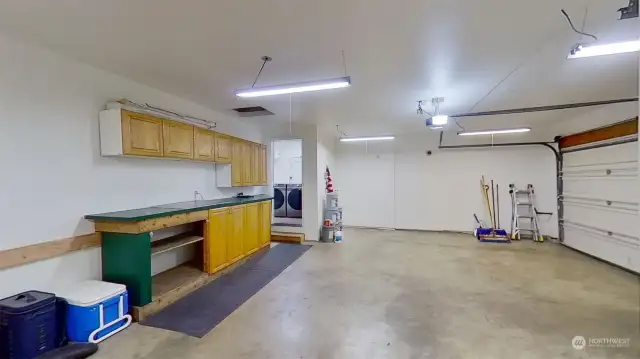 Spacious 3-car garage with built in work station and storage