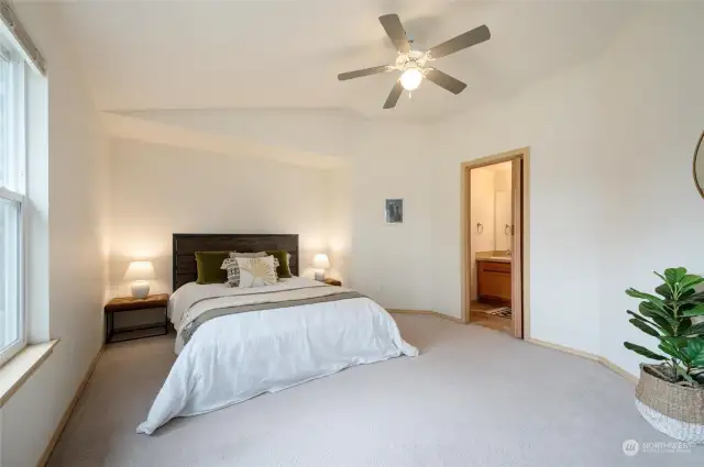 The spacious primary bedroom has vaulted ceilings and a large en-suite bathroom. There is also a walk in closet in the bathroom.