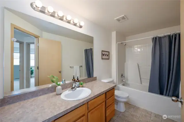 This is the second full bathroom located on the second floor. The large vanity with a single sink provides lots of additional counterspace and storage for all the necessities and then some!