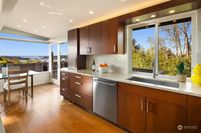 An abundance of pull out drawers, a large stainless sink & recessed/hidden power outlets.