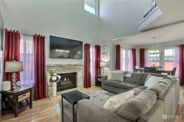As you enter, you will find an amazing 2-story family room with lots of light, beautiful flooring and a gas fireplace to keep you cozy on cooler evenings. Dining room straight ahead.