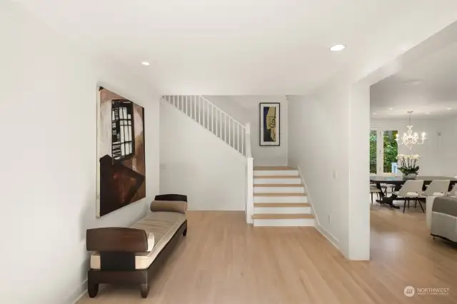 Upon entry, you're greeted by a bright, open floor plan with newly refinished maple hardwood floors that exude a crisp, modern Northern European aesthetic.