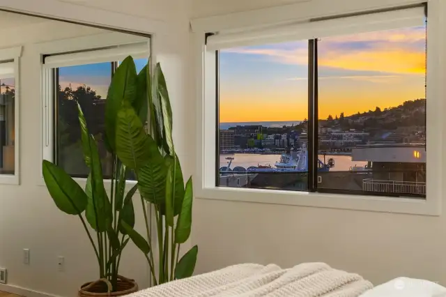 sunset views of lake and space needle from primary bedroom