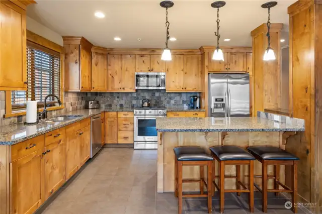 Beautifully appointed kitchen with ample cabinets for great storage and counter space for your entertaining needs.
