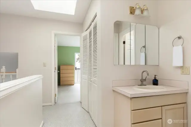 bathroom sink nestled just outside additional two bedrooms