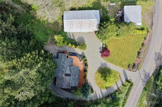 Aerial view of the home, shop, lower lawn and circular drive. *Building in the upper right is the neighbors property*
