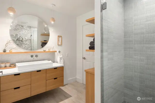 Main floor guest bath, with gorgeous handmade cabinetry, open shelving, a real serene space.