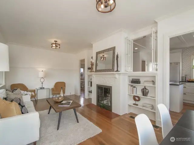 Nicely updated and bathed in natural light! Beautiful Oak and Fir floors. Original brick fireplace with built in bookcases. Crown molding, wainscotting add to the appeal!
