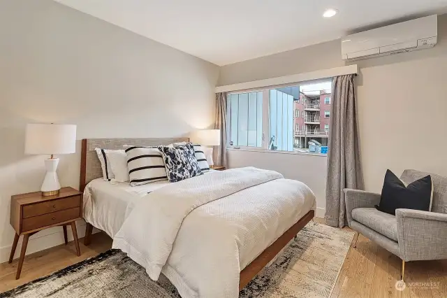 Lower Level Bedroom with hardwood floors, mini-split, large picture window and custom California Closets.