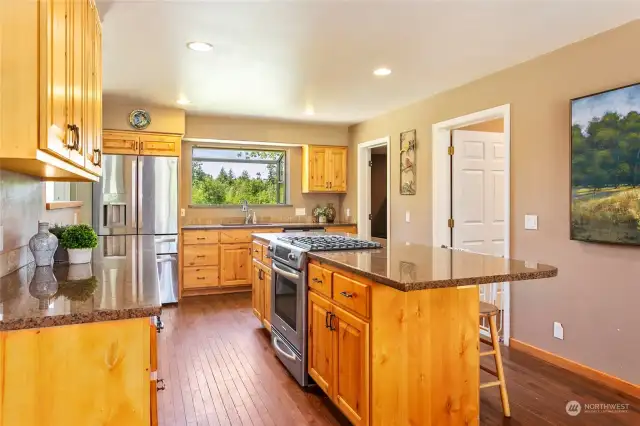 Updated kitchen features granit counters, stainless appliances and opens to the dining and living areas.