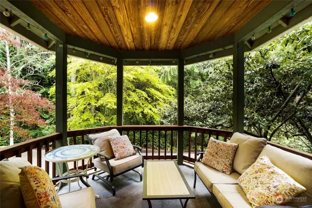 Just off the living room, dining room and kitchen is this darling covered deck.
