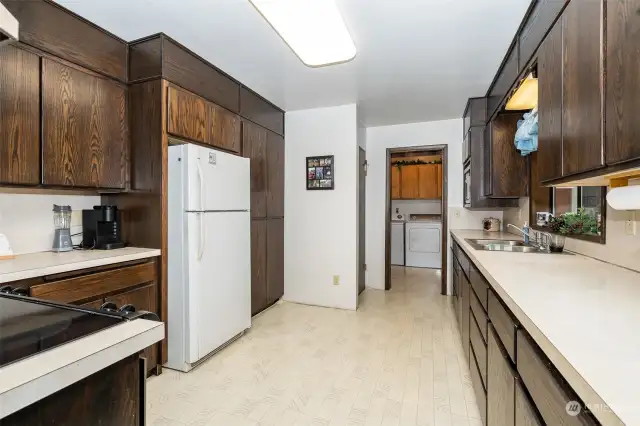 Laundry room is near the kitchen in this floor plan.