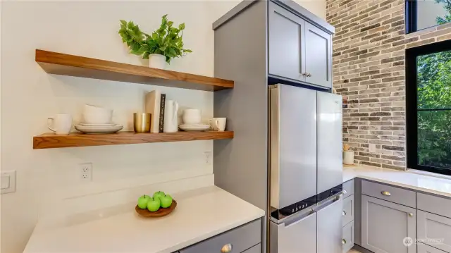 Additional counter space, stainless fridge/freezer and more of the stylish floating shelves.