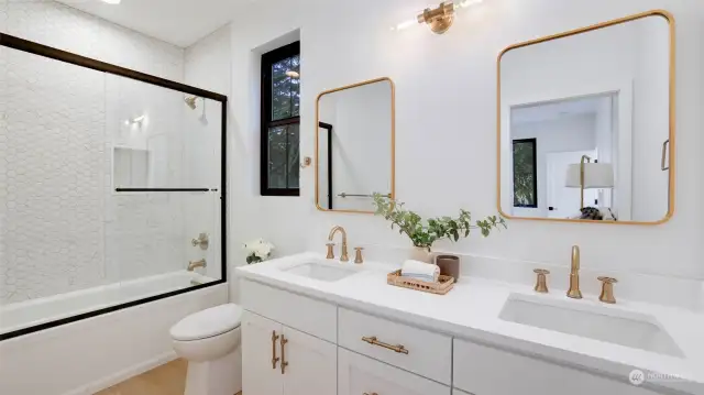 Oh, this bathroom is beautiful! Masterful tilework, oversized vanity space and gold tones that pop.