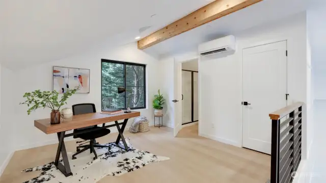 The upper level loft/office space features more of the vaulted ceiling and exposed beam. You'll also find a storage closet and 3/4 bath that could be a perfect guest area or 2nd bedroom.