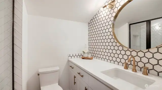 The 3/4 bath off the loft/office space boasts more of there beautiful tile work and gold tones that tie these rooms together.