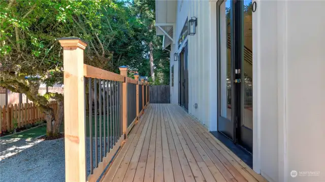 Large deck runs along the front of the home and leads to an additional private outdoor space.