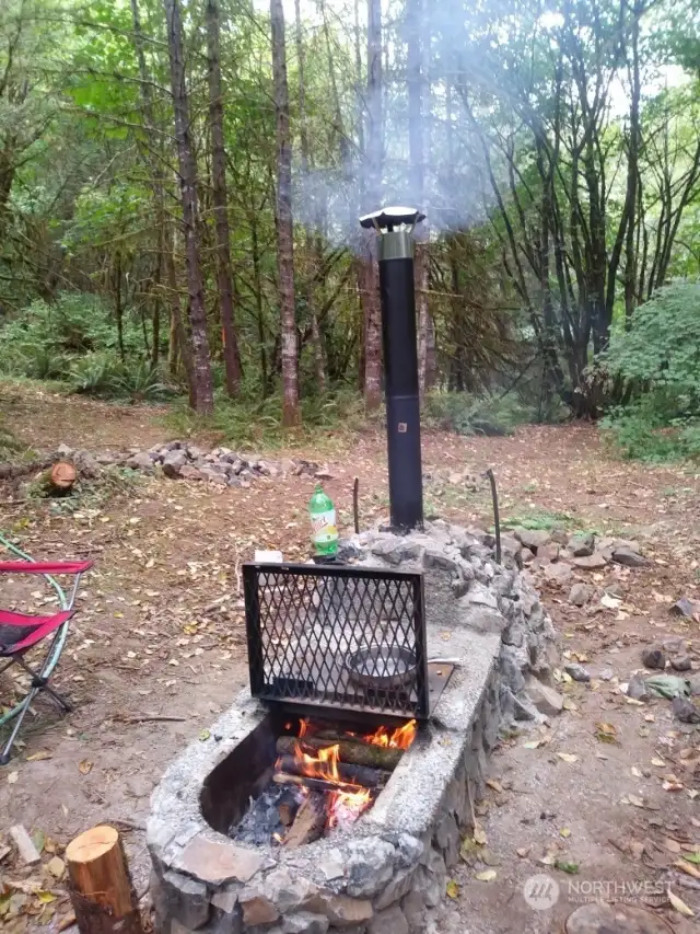 Campground area includes grated fire grill with chimney