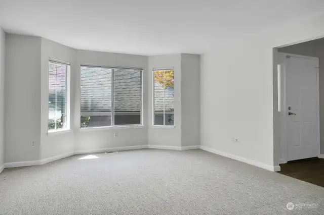 Cozy living room with bay window, lots of natural light. Fresh paint & New carpet throughout!