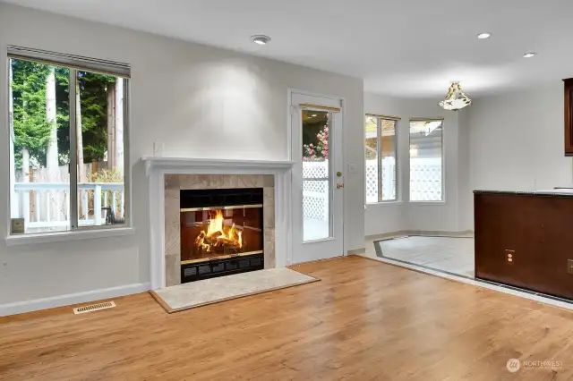 Family Room off kitchen with fireplace, lots of windows brings nature in.