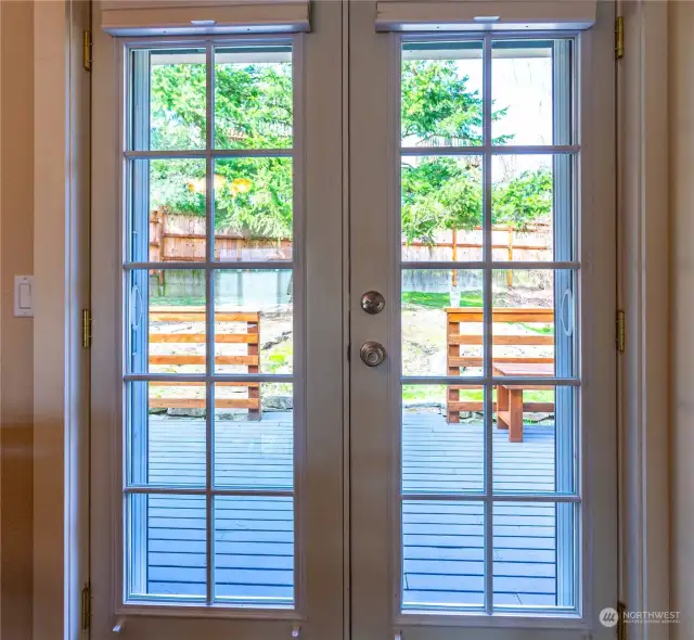 French doors off the dining room lead to a spacious back yard