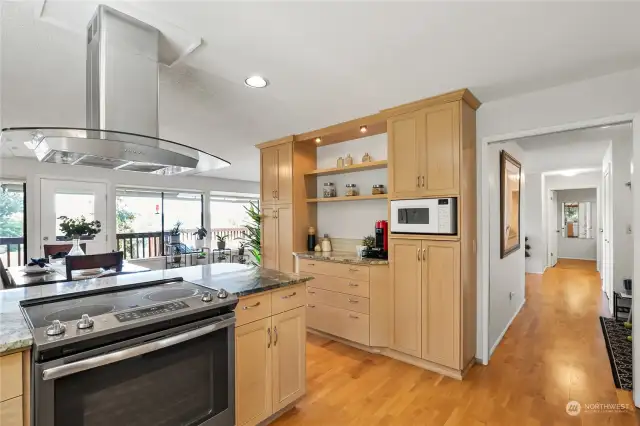 Check out this view... Even from the kitchen you'll have views of Puget Sound through all the large windows! Hallway goes to bathroom and stairs.