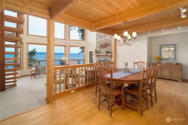 Formal dining area boasts built ins, tongue and groove beamed ceilings and wide water views. Full height fireplace warms you. Gatherings will be fabulous here!