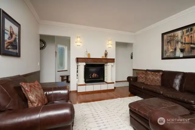 Formal living room with propane fireplace and access to the large deck on the back side of the home.