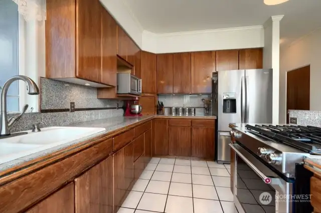 Kitchen view with tile floors and newer appliances.