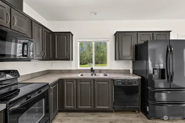 Beautiful cabinetry is in plenty, as well as a walk-in pantry in the corner