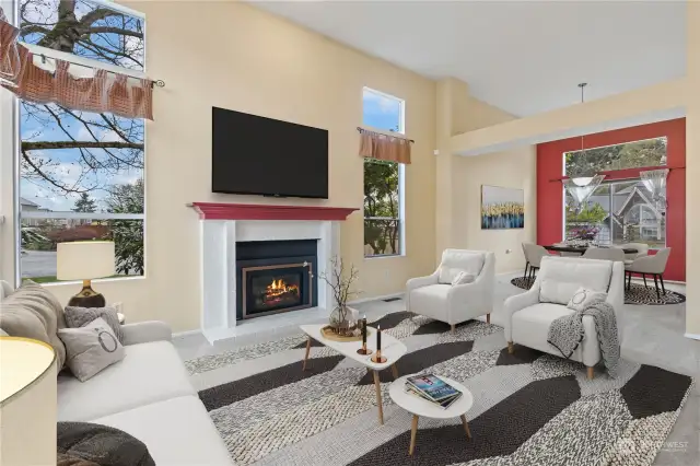 Virtually staged. Formal living room warmed by a gas fireplace.