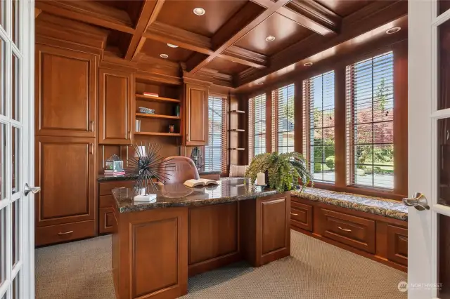 Luxurious study/library with extensive wood millwork design. The intricately coffered ceiling, window seat & built in cabinetry are extraordinary.