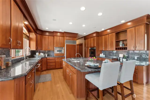 Sophisticated and practical kitchen adorned in stainless steel, granite counters & backsplash, gas cooktop & extensive timber flooring. This stunning custom kitchen also comes with a huge central island, vegetable sink, Sub Zero refrigerator & alfresco deck access.