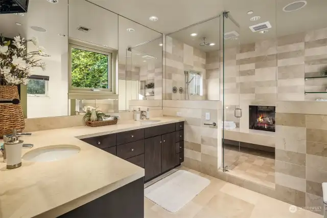 Luxurious Primary bath. Italian marble, two sinks, separate wet area with shower, tub and double sided gas fireplace.  Separate make-up/vanity station.