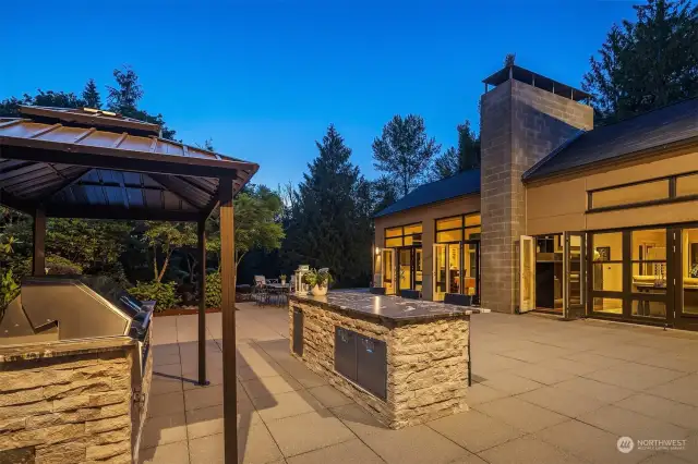 Outdoor kitchen done by LUWA of Bellevue. Hestan Aspire Grill, drop-in cooler, and stone island/bar with garbage/recycle drawers and storage cabinets.