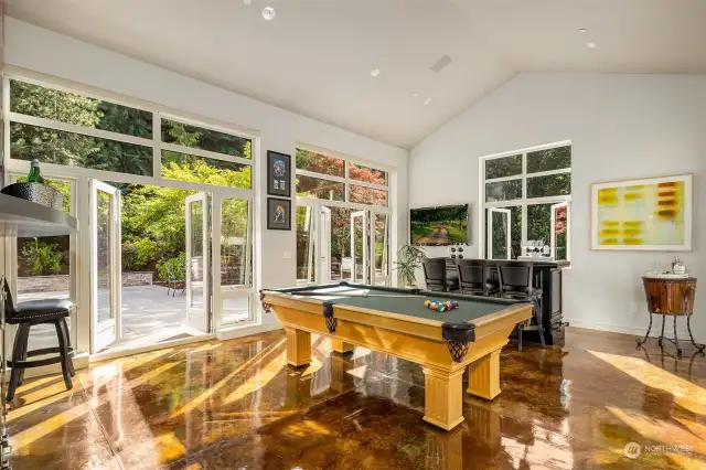 This home is for entertaining! Imagine the party potential with this amazing game room on the main level.  Opens up to sprawling outdoor space.  True indoor outdoor living at its finest.