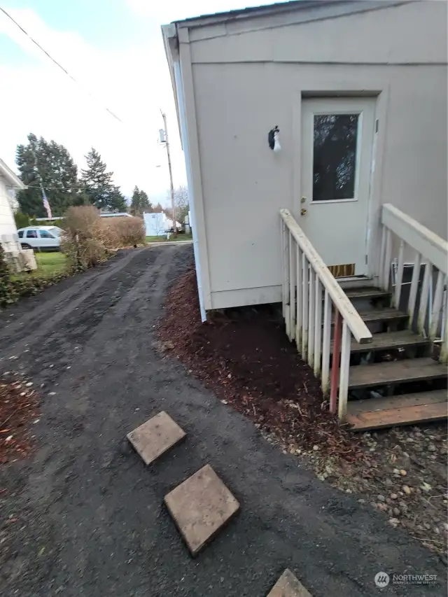 The backdoor if the house and driveway.