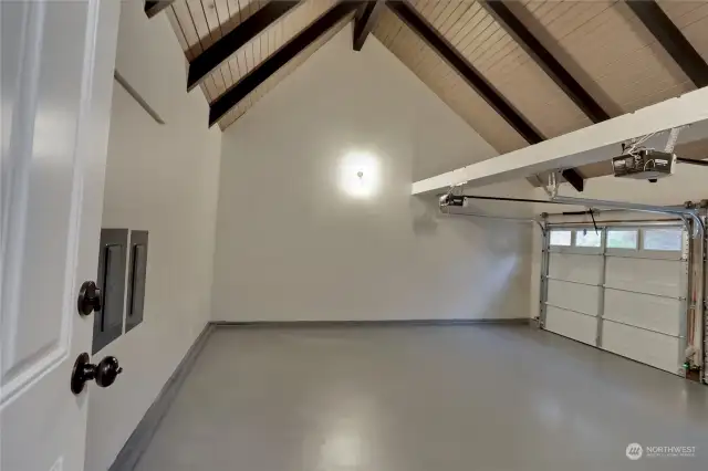 A 2-Car Garage w/Wow Factor!! Check out those ceilings! You'll find TWO 200-Amp Panels here! New Garage Doors w/Windows and Openers, Newly Epoxied Garage Floors and yes, even a lovely wall sconce to provide extra light.