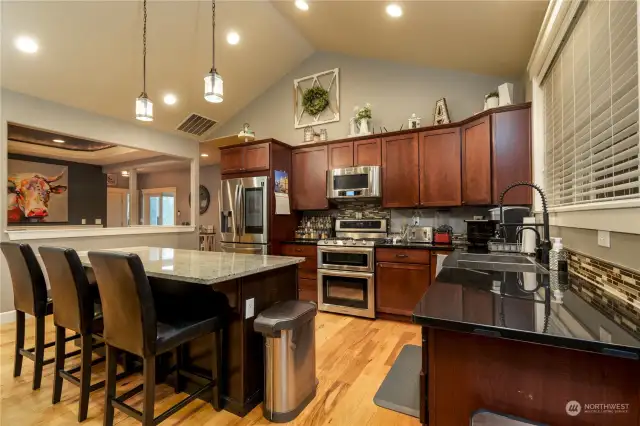 Open concept kitchen with breakfast bar. Perfect space for entertaining a large group. Access to outdoor space off living room.