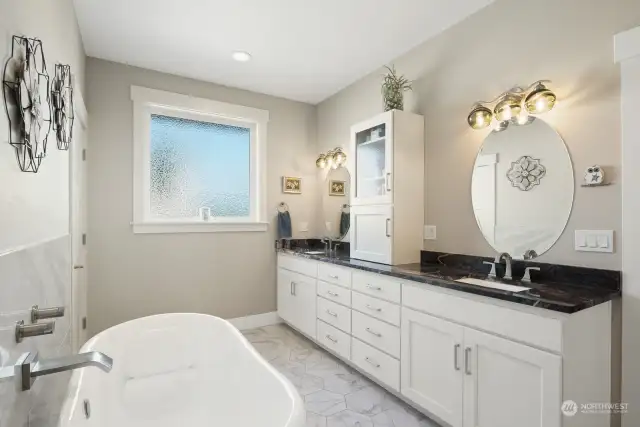 Extra-Large Primary Bathroom complete with Signature Hardware Clawfoot Soaking Tub, dual sinks, private water closet, thoughtful storage, walk-in closet  and 7' walk-in shower.
