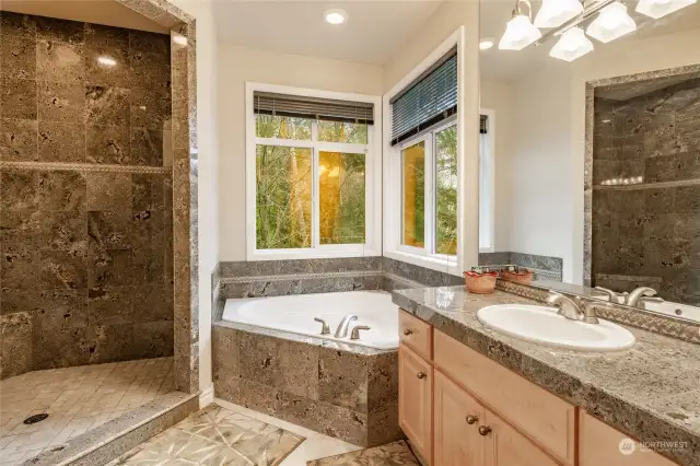 Primary bath with granite shower, tile flooring, double sinks, lots of space